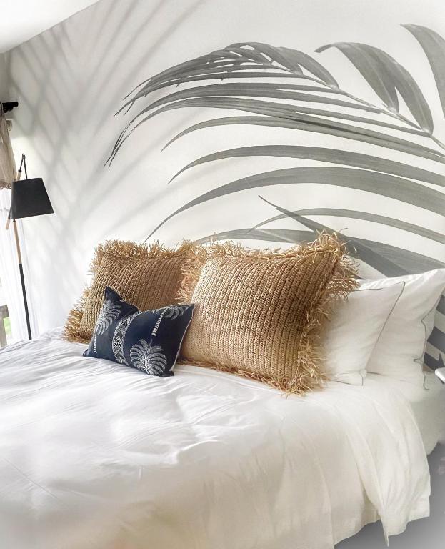 a bedroom with a white bed with pillows on it at Voelkliplaan 8 in Jongensfontein