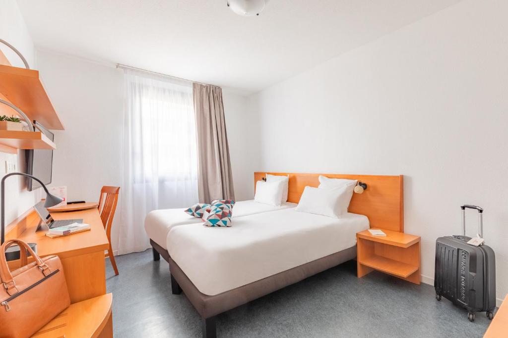 Postel nebo postele na pokoji v ubytování Appart’City Confort Lyon Gerland