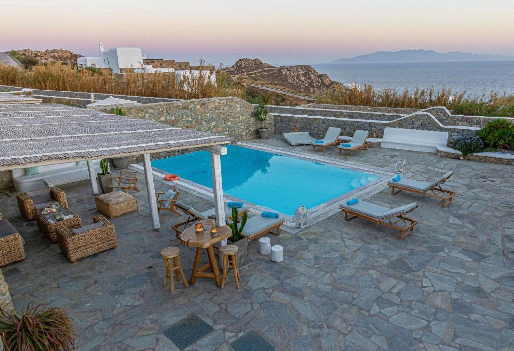 a villa with a pool and a view of the ocean at Villa Mando in Super Paradise Beach