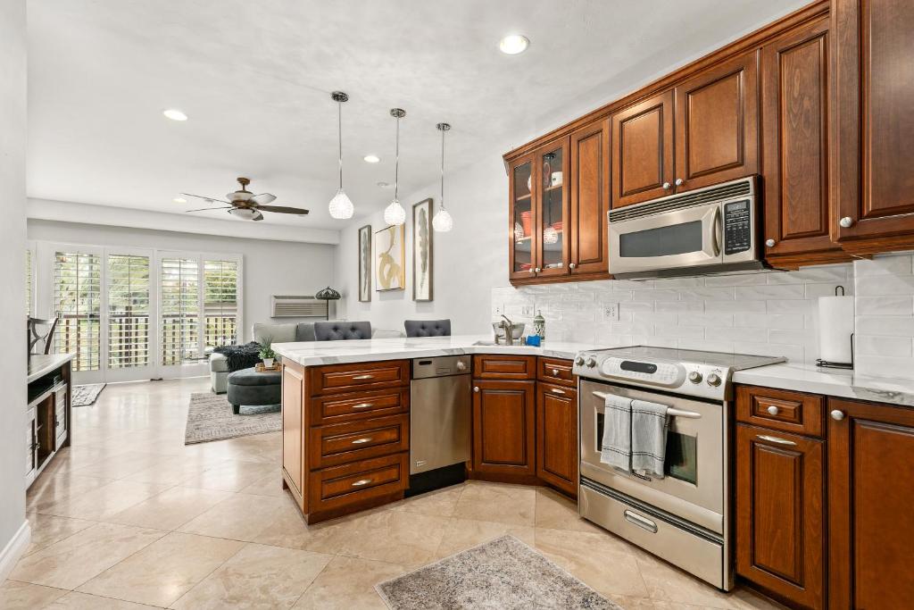 a kitchen with wooden cabinets and a stove top oven at 683 Just inside the gates of the Resort - Golf & Premier Fitness Guests Welcome in Encinitas
