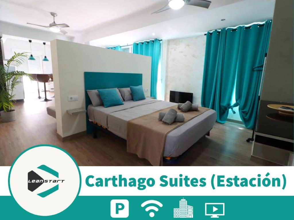 a bedroom with a large bed with blue curtains at Carthago Suites in Cartagena