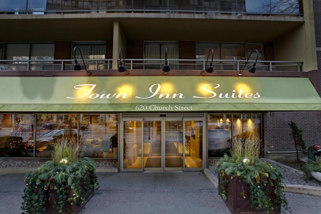 a restaurant with a neon sign on the front of it at Town Inn Suites in Toronto