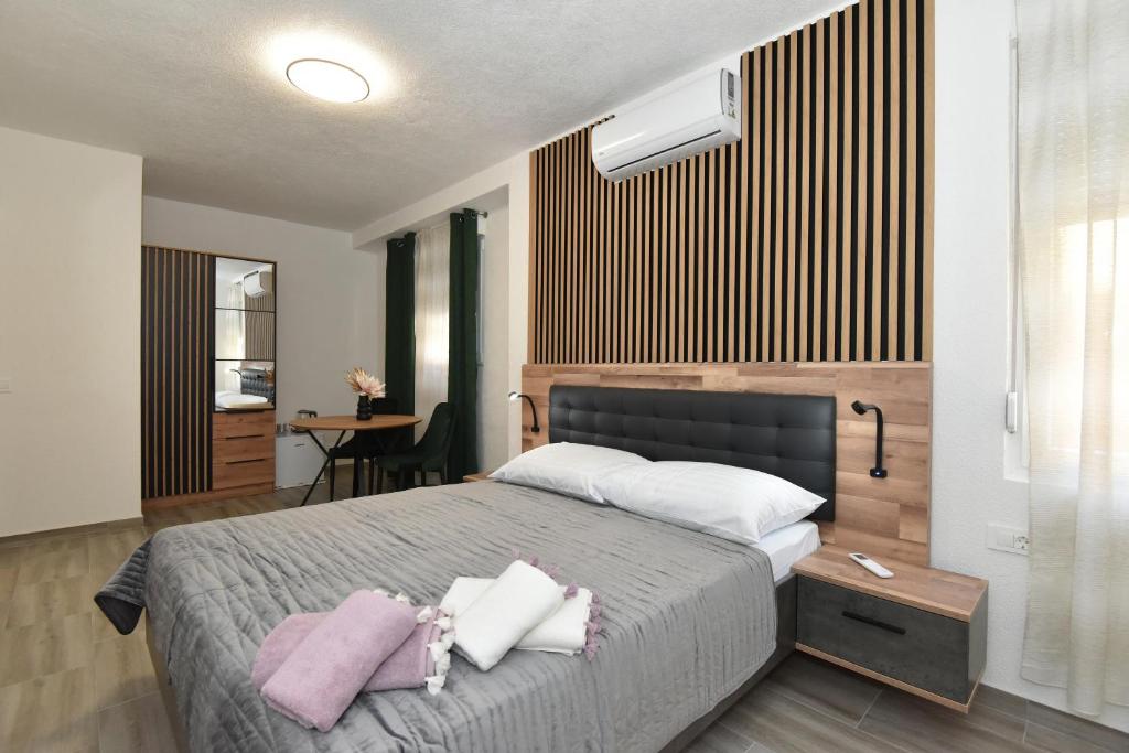 a bedroom with a large bed with two towels on it at SOFIA'S Studio & Room in Zadar