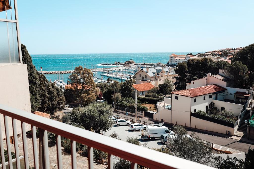 a view from a balcony of a town and the ocean at Appartement Miramar in Banyuls-sur-Mer