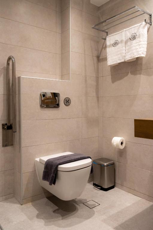 a bathroom with a toilet with a towel on it at Nissos Apartments in Myrina
