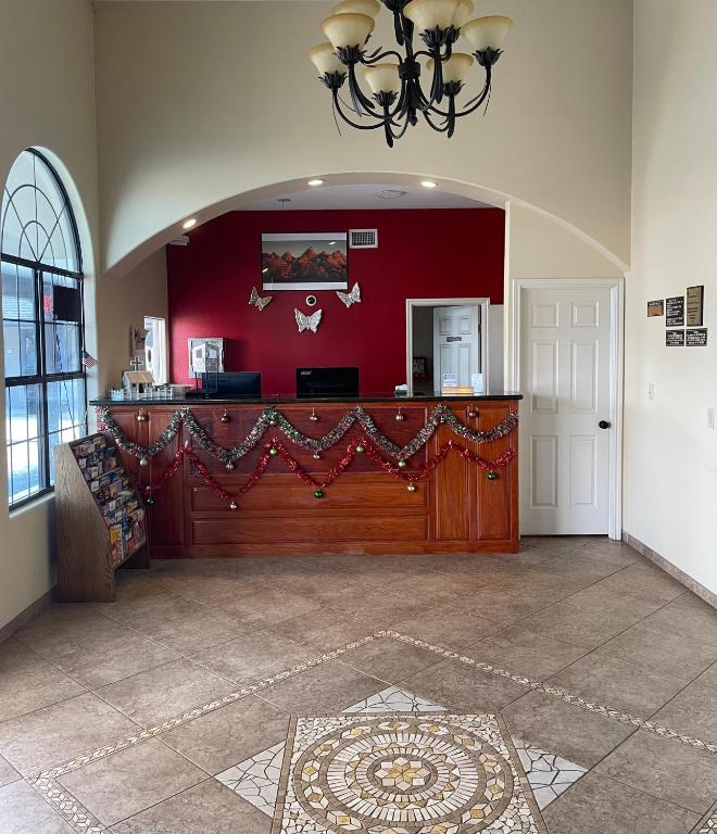 a large room with a red wall and a counter at Riviera Inn and Suites in Riviera