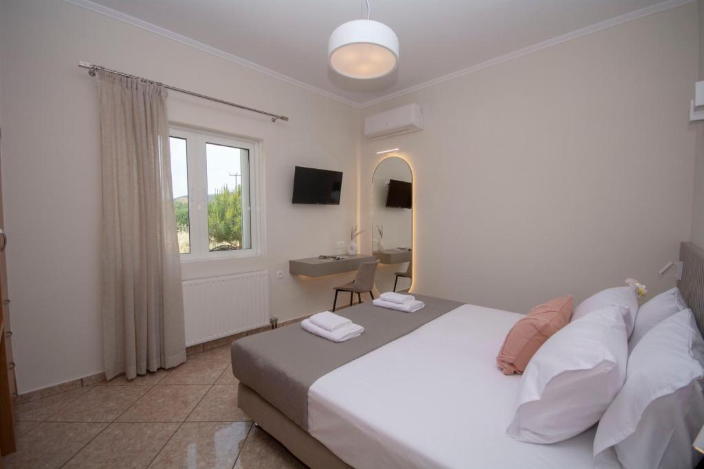 a bedroom with a bed and a sink and a window at Villa Kalliestia, sea view veranda and garden in Kissamos