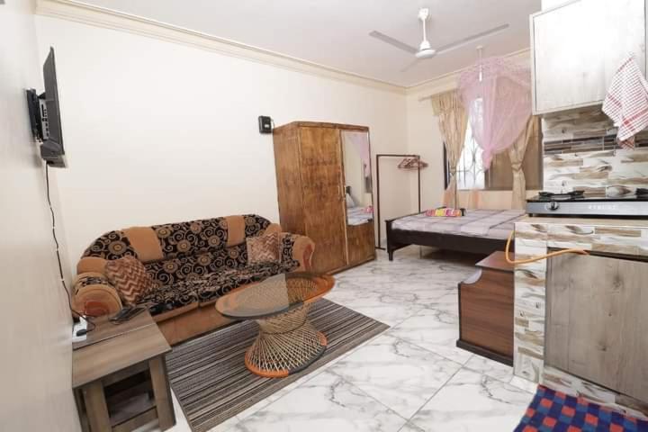 a living room with a couch and a table at Lux Suites Ganjoni Studio Apartment in Mombasa