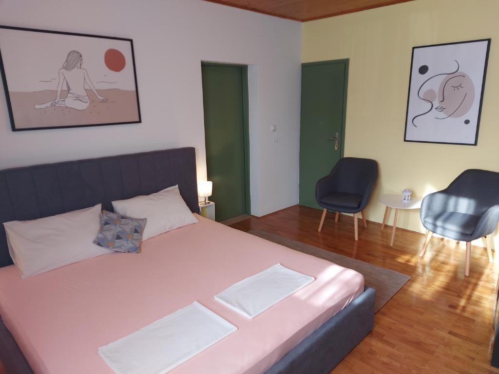 um quarto com uma cama grande e 2 cadeiras em Olive Tree em Zadar