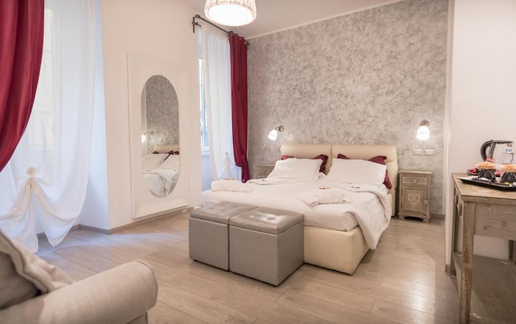 a bedroom with a large white bed and a chair at Your Vatican Suite in Rome