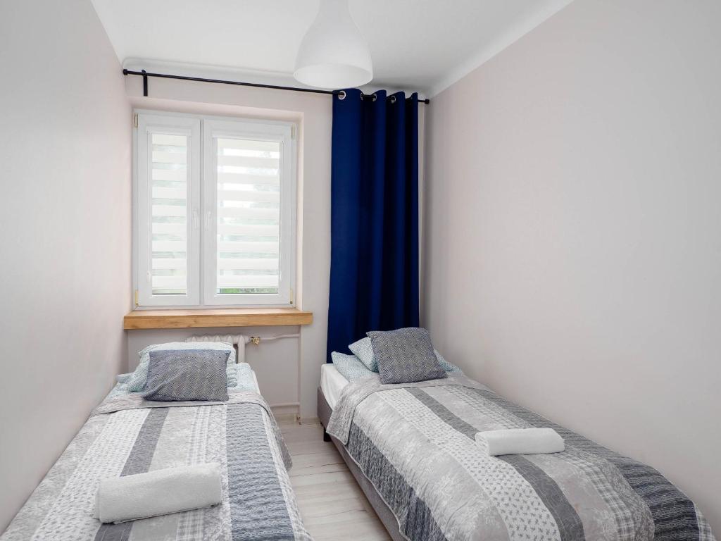 Posteľ alebo postele v izbe v ubytovaní VISTULA two-bedroom Apartment
