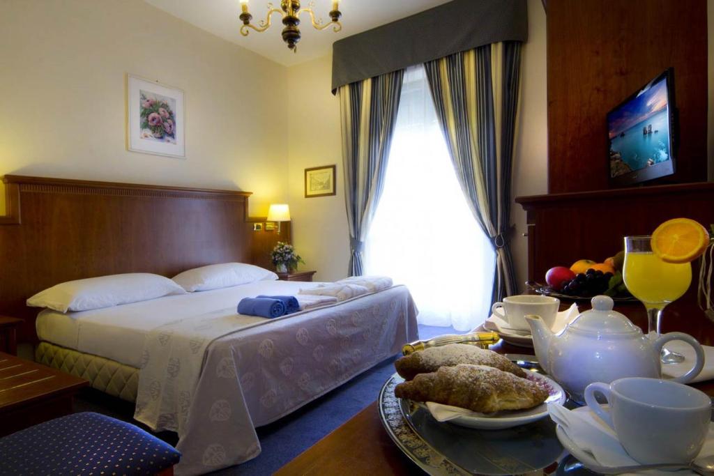Postel nebo postele na pokoji v ubytování Hotel Posta