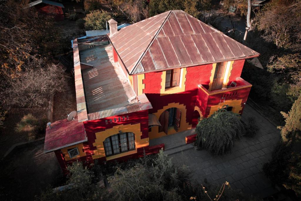 an overhead view of a red house with a roof at Hostal Los Castaños in San Alfonso