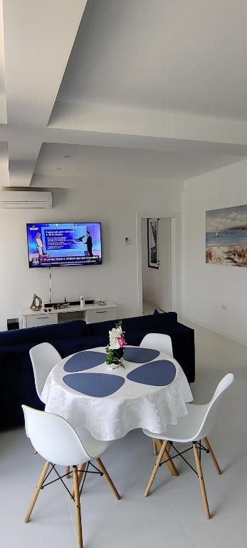 a living room with a table and chairs at Euphoria Neptun Oxygen in Neptun
