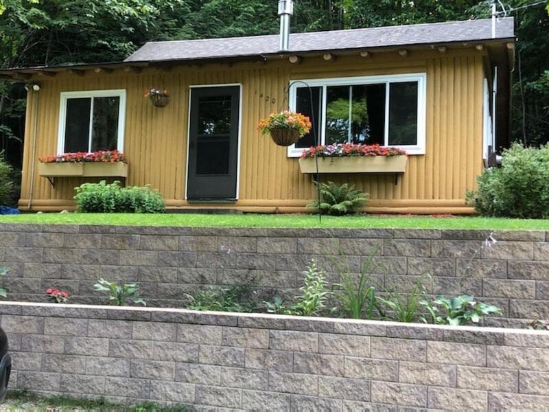 a small house with two windows and flower boxes at The Crystalaire Cabin - Charming And Relaxing! in Frankfort