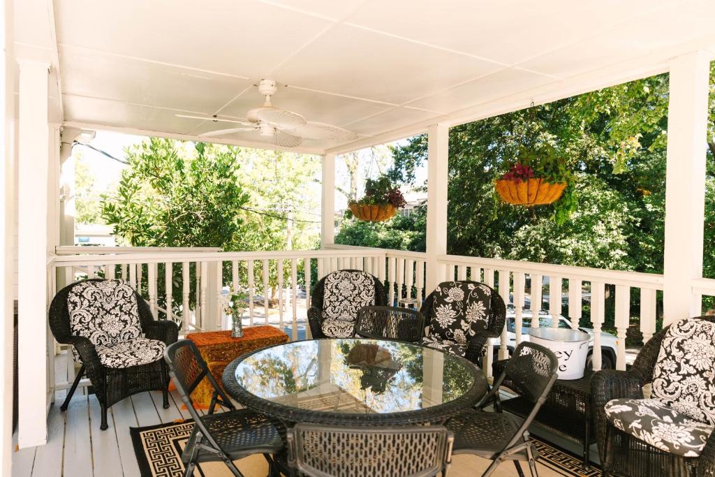 a screened porch with a glass table and chairs at Stanley House Inn in Marietta