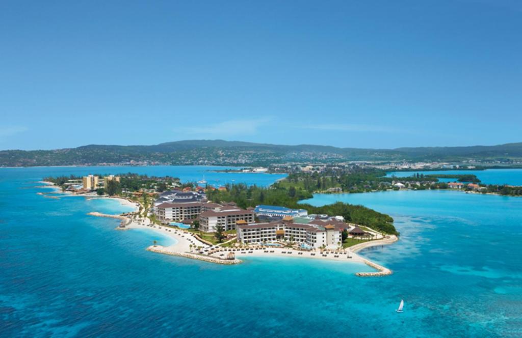 an aerial view of a resort on a island in the water at Secrets Wild Orchid in Montego Bay