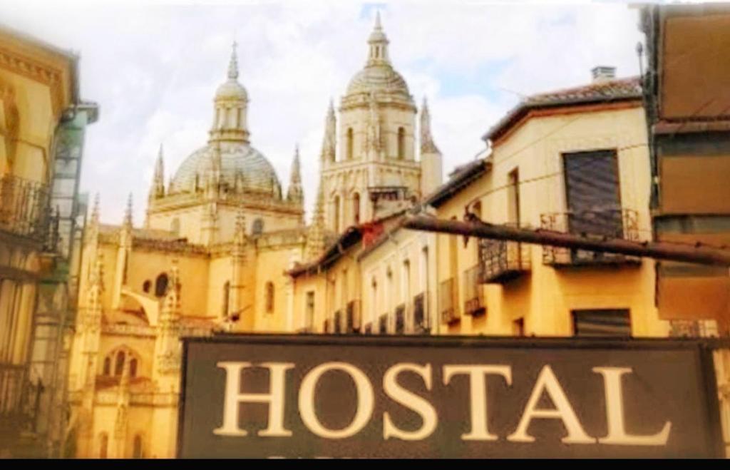 a hospital sign in front of a building at Hostal Plaza in Segovia