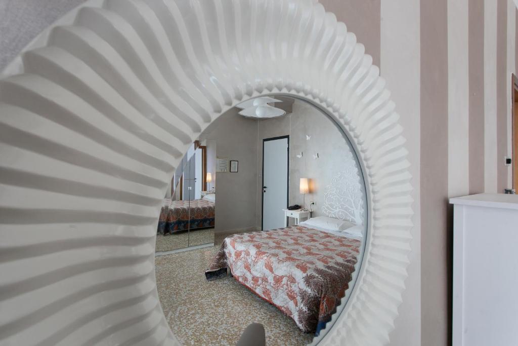 Postel nebo postele na pokoji v ubytování Hotel Mirabello