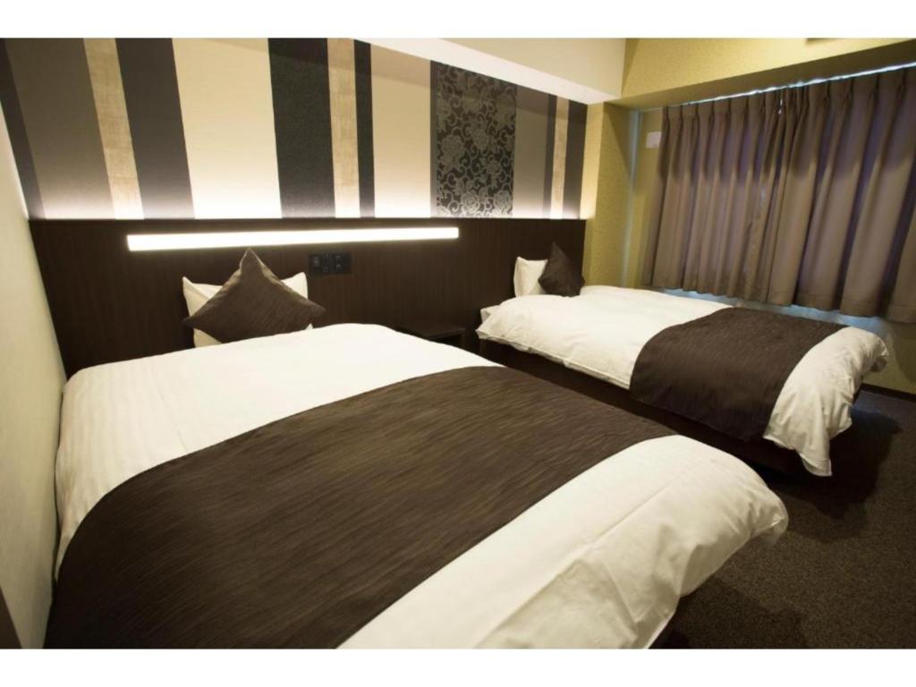 a hotel room with two beds in a room at HOTEL LANTANA OSAKA - Vacation STAY 49019v in Osaka