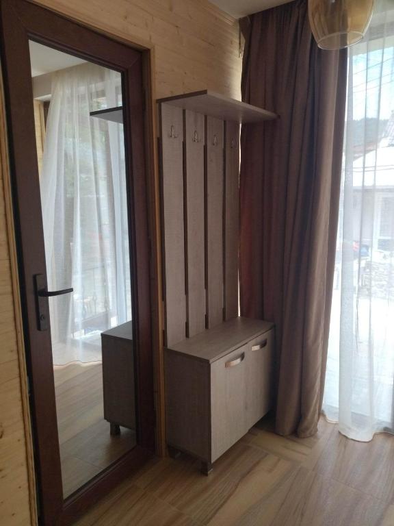 a mirror in a room with a dresser next to a window at DATI in Borjomi