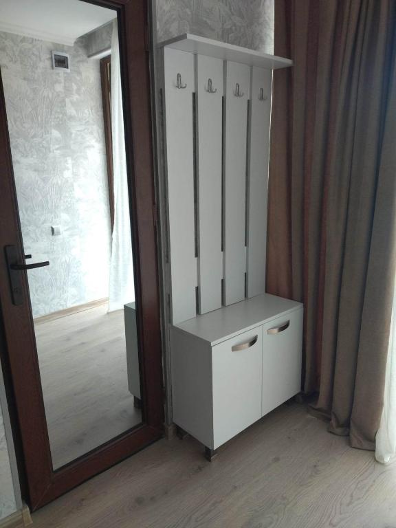 a white cabinet in a room with a mirror at DATI in Borjomi
