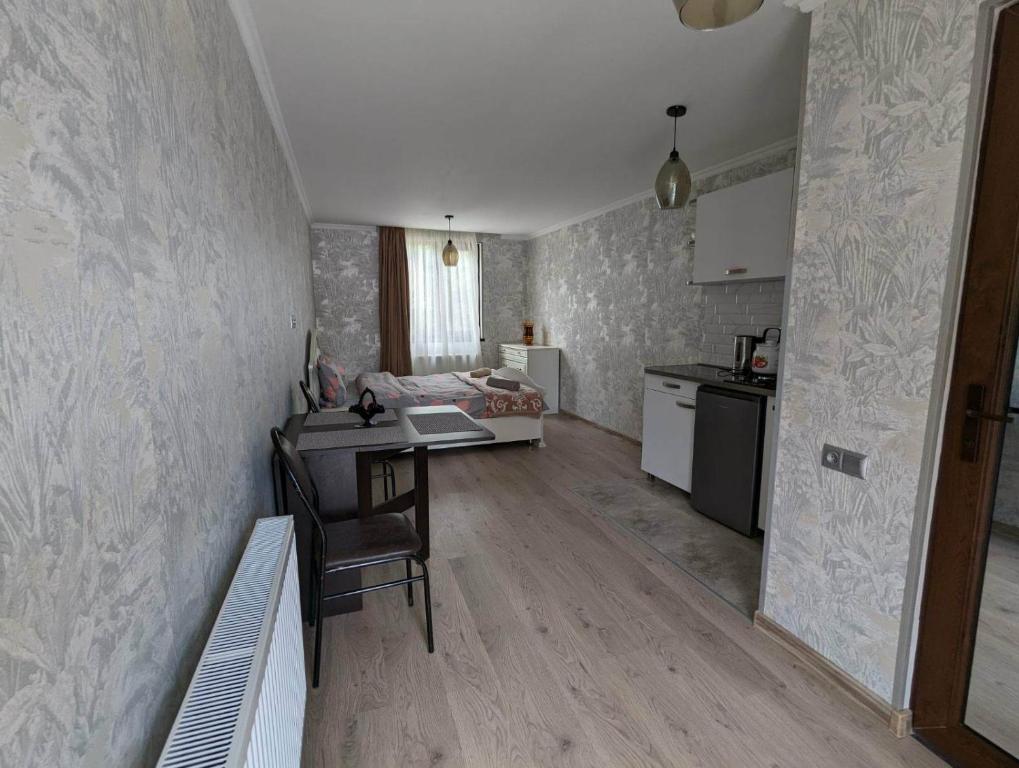 a room with a kitchen and a table and a desk at DATI in Borjomi