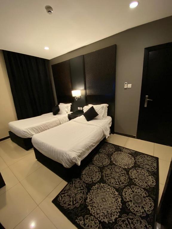 Postel nebo postele na pokoji v ubytování Al Taif Suites - Al Faisaliah