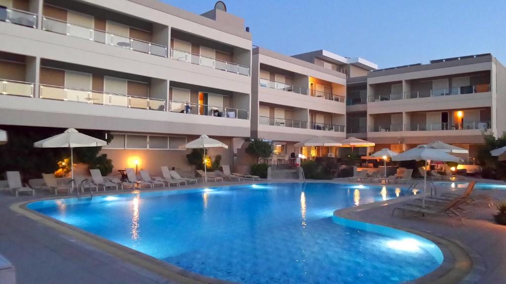 a swimming pool in front of a hotel at Agela Hotel & Apartments in Kos