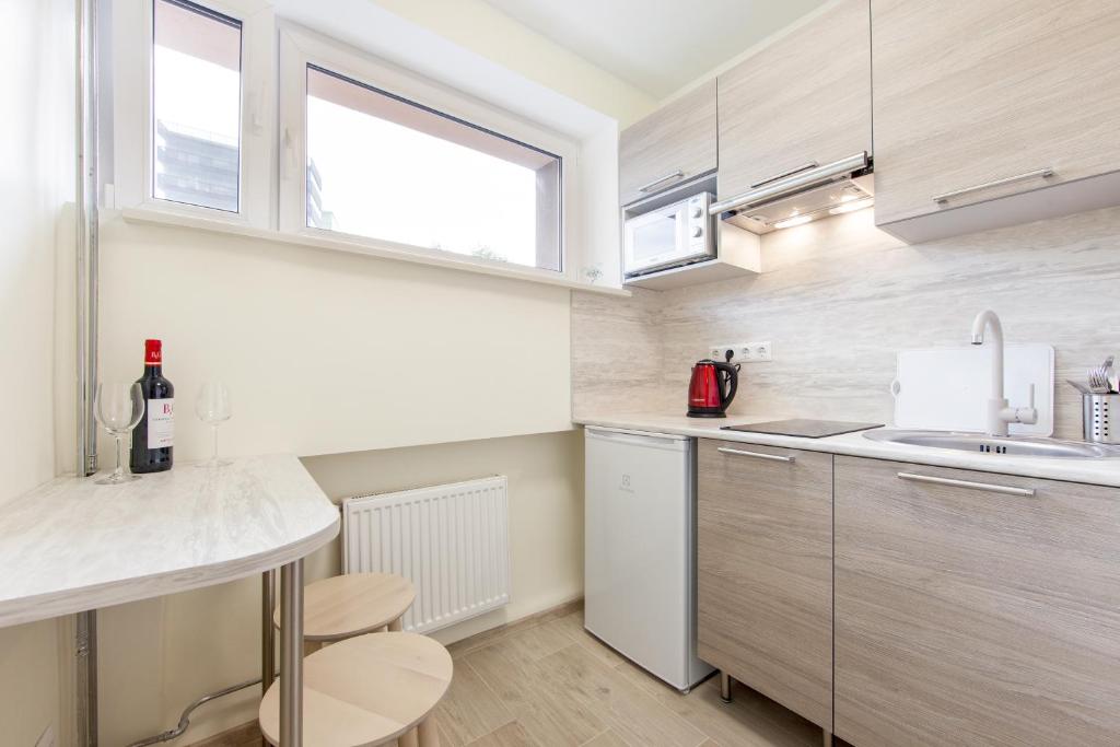 a small kitchen with a counter and a sink at Bright Apartment near Bus Statioon in Tallinn