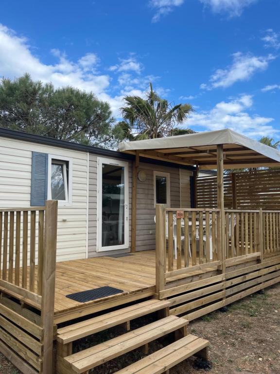 a house with a wooden deck with a gazebo at Mobil Home de Marine in Port-la-Nouvelle