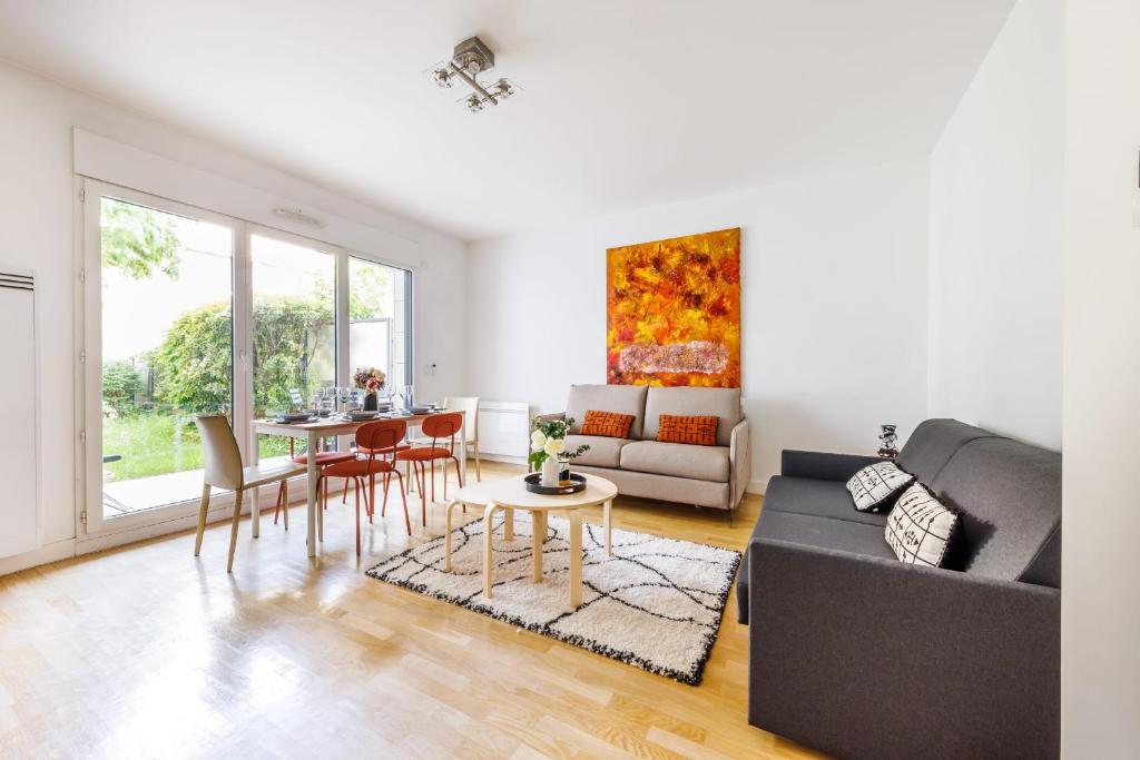 a living room with a couch and a table at Comfortable Home with Garden - 1BR6P - Vanves in Vanves