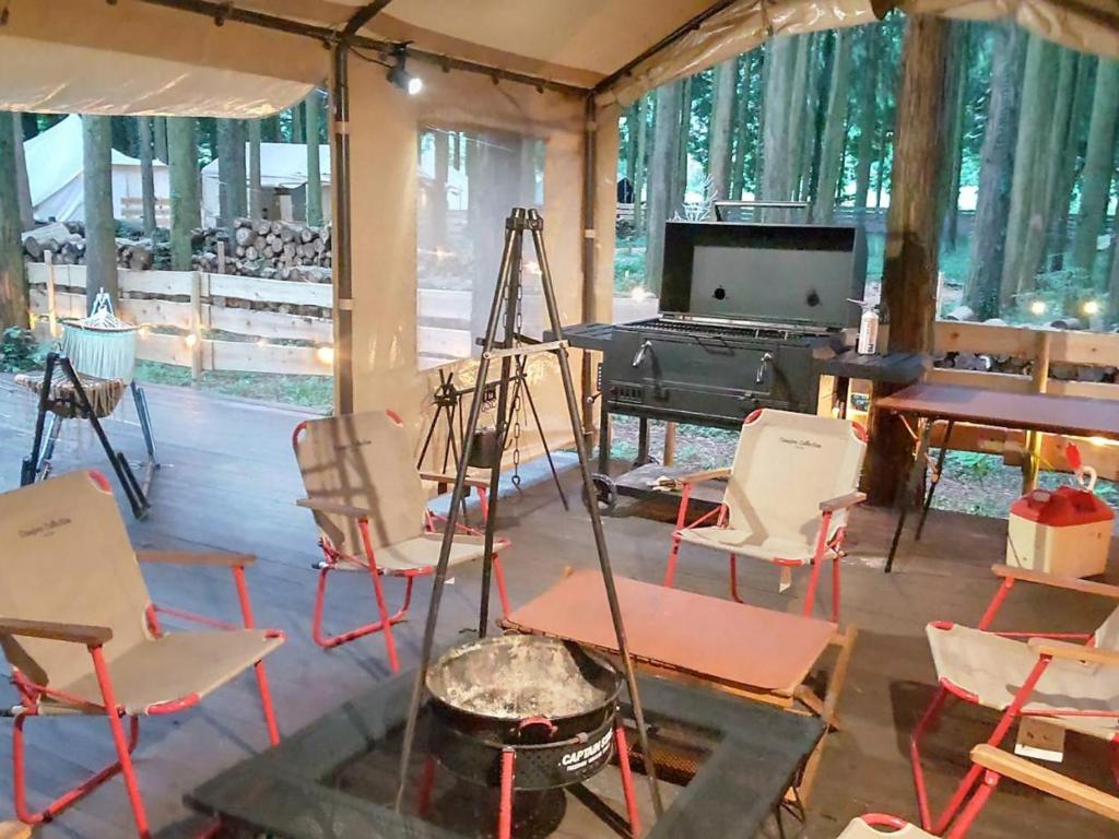 a room with chairs and a piano and a table at Minamiaso STAYHAPPY - Vacation STAY 35413v in Shimoda