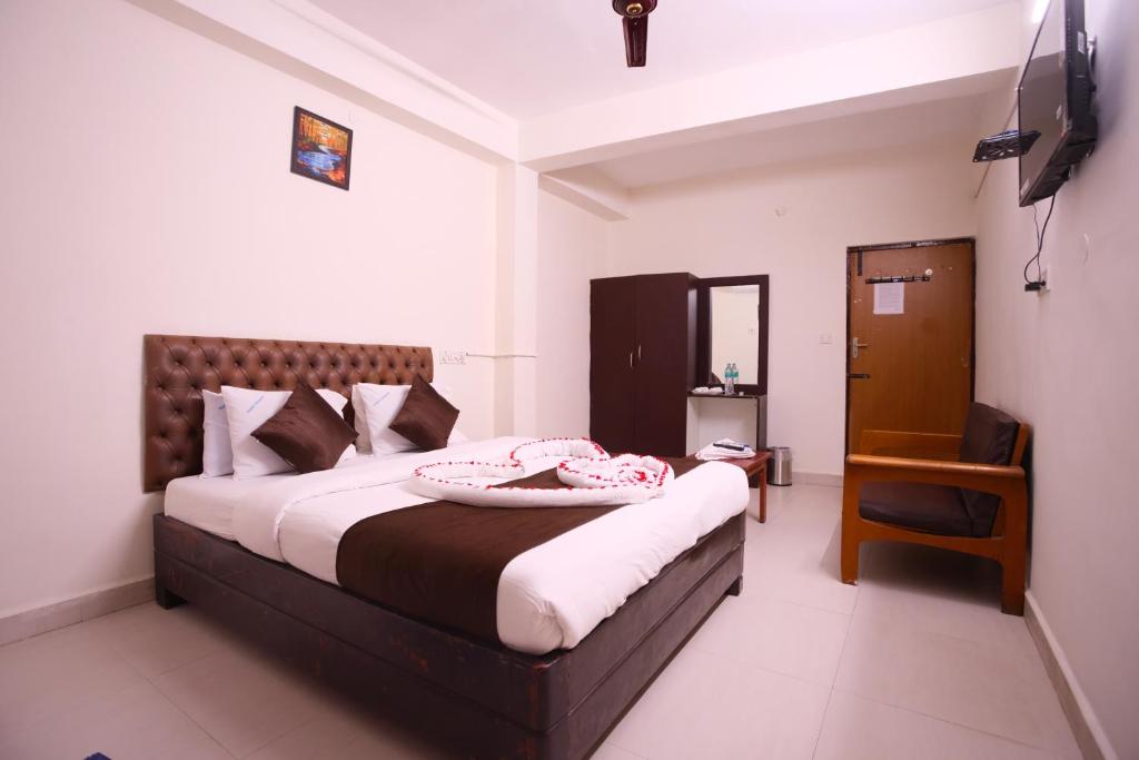 Postel nebo postele na pokoji v ubytování Ganesh Guest House