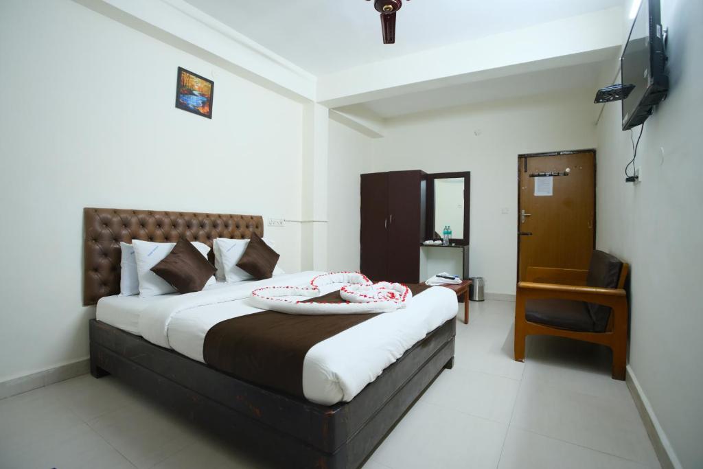 Postel nebo postele na pokoji v ubytování Ganesh Guest House