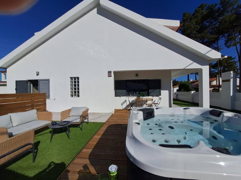 a hot tub in the backyard of a house at Villa Ocean Waves in Aroeira