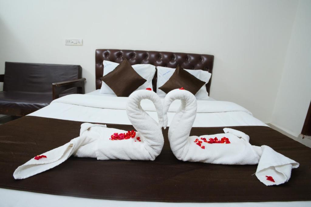 Postel nebo postele na pokoji v ubytování Ganesh Guest House