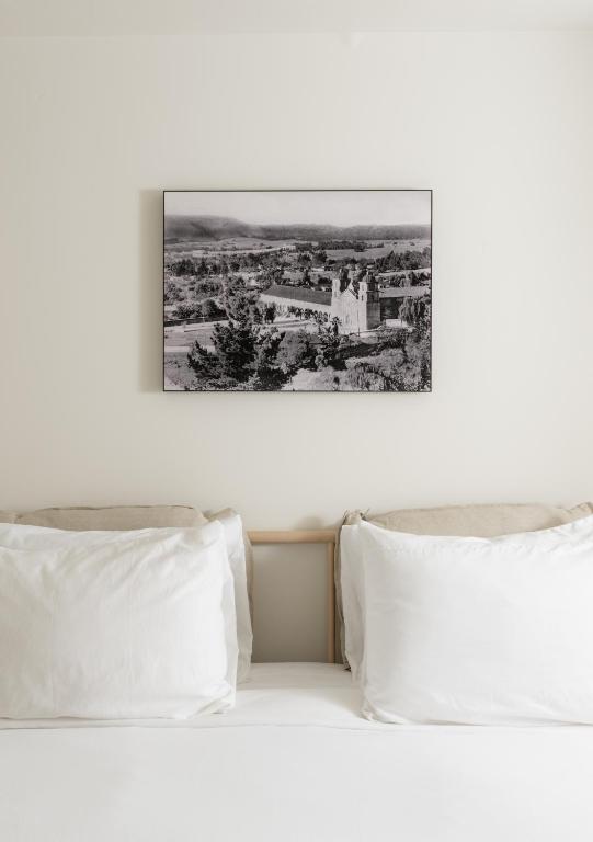 two white pillows on a bed with a picture above them at The Franciscan Hotel in Santa Barbara