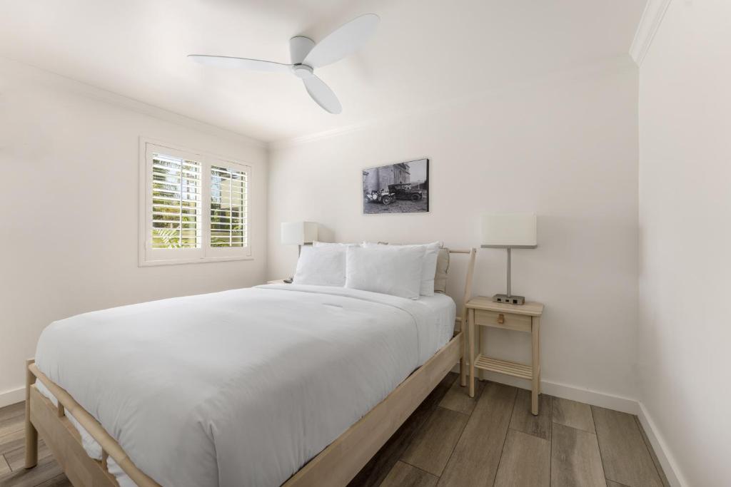a white bedroom with a large bed and a window at The Franciscan Hotel in Santa Barbara