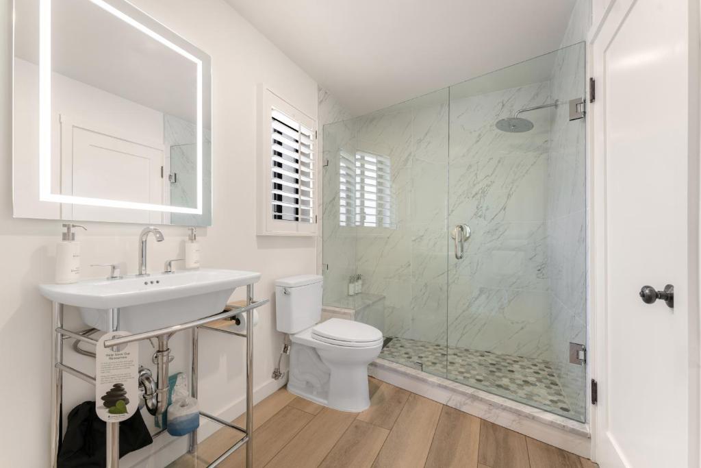 a bathroom with a toilet and a sink and a shower at The Franciscan Hotel in Santa Barbara
