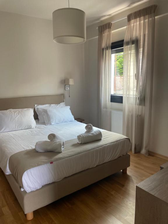 a bedroom with a bed with two towels on it at Agnanta Mountain Residence in Agnanta