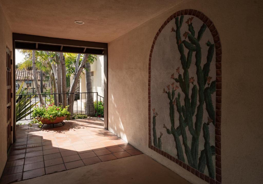 a mural of a cactus on a wall in a hallway at The Franciscan Hotel in Santa Barbara