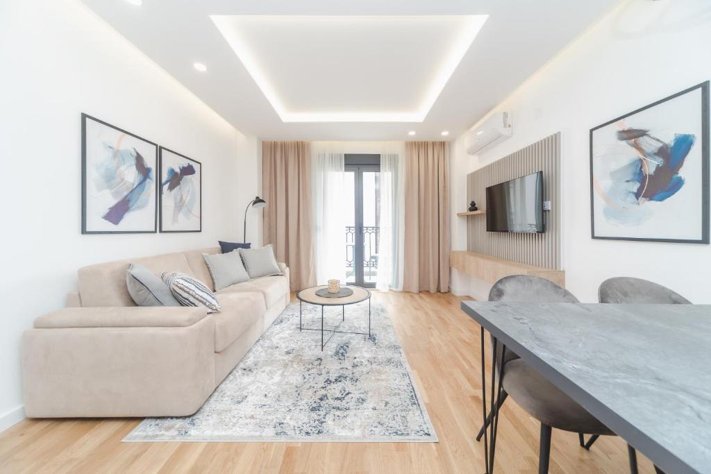 a living room with a couch and a table at Salus Hill Condo with private Garage in Budva