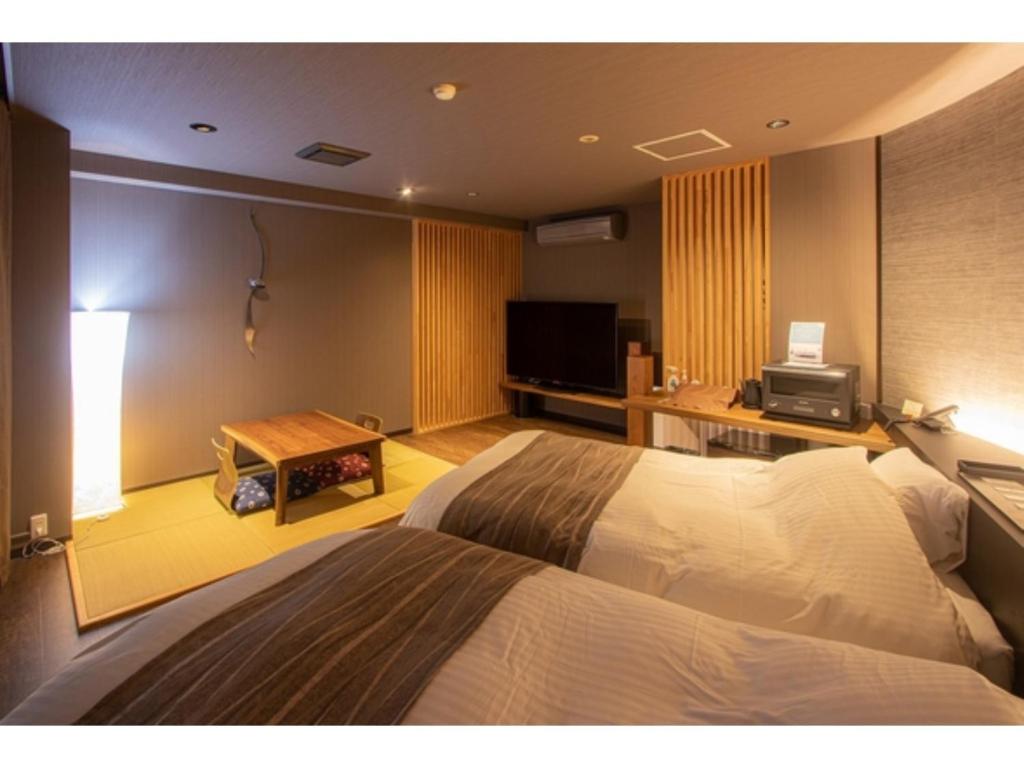 TV tai viihdekeskus majoituspaikassa Oita Onsen Business Resort Kyuan - Vacation STAY 50161v