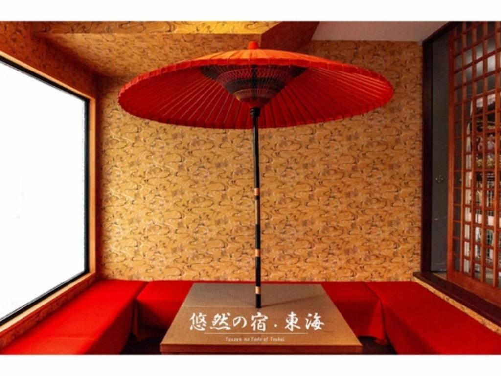 a red umbrella sitting on top of a table at Yuzennoyado Toukai - Vacation STAY 57658v in Ureshino