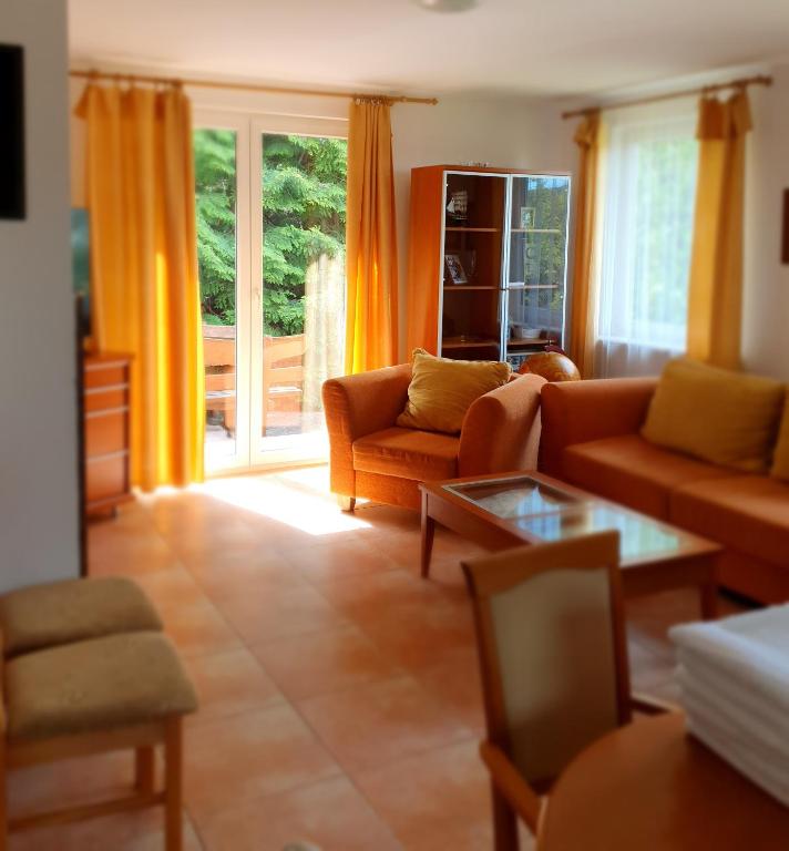 a living room with a couch and a table at Dom Kapitana in Mikołajki