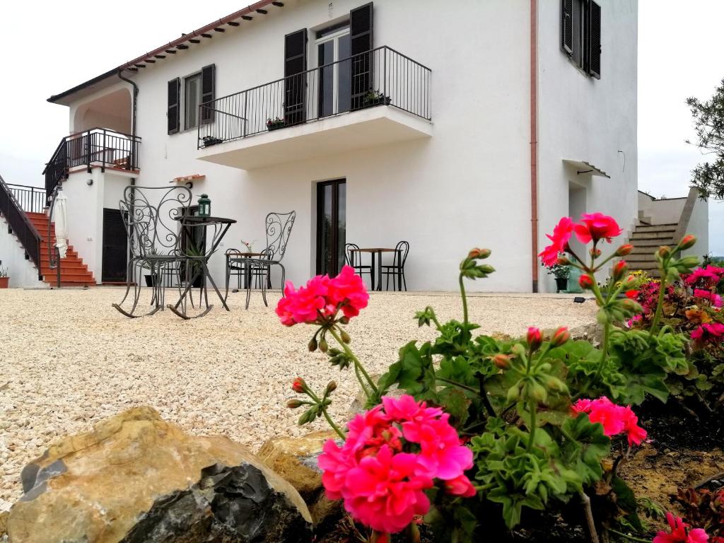 een huis met roze bloemen ervoor bij Agriturismo Podere Verdicchio in Scansano