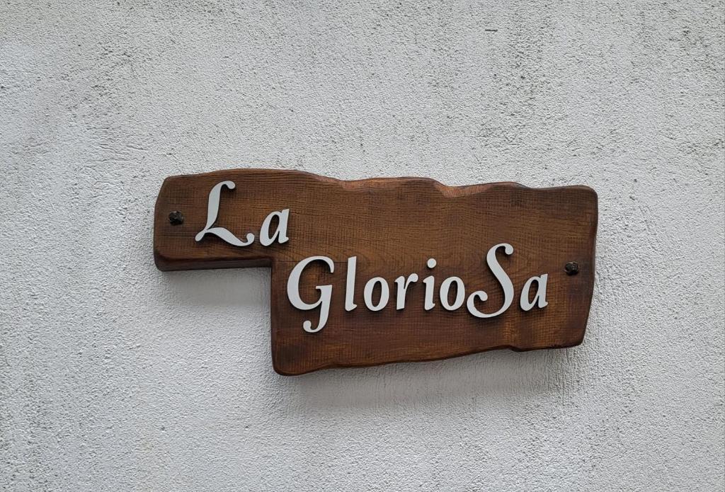 un panneau en bois sur le côté d'un mur dans l'établissement Casa la GlorioSa, à Gravellona Toce