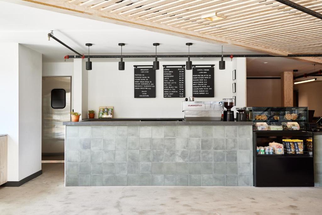 a restaurant with a counter in a room at Field Station Moab in Moab