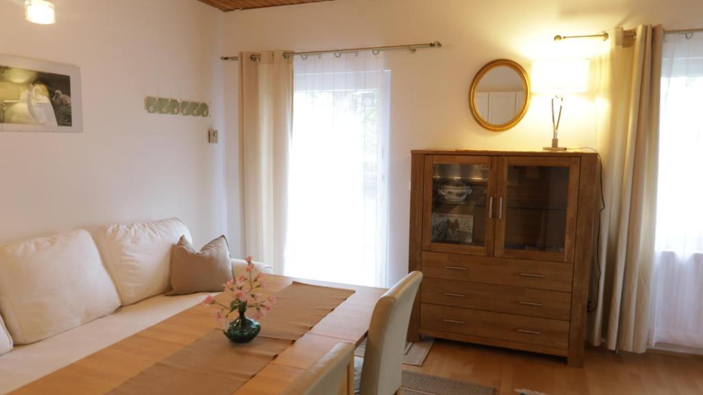 a living room with a couch and a table at Ferienwohnung Schwanensee in Lenzing